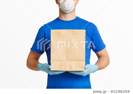 Delivery during coronavirus 2019-nCov in pandemic. Courier in uniform 65296309