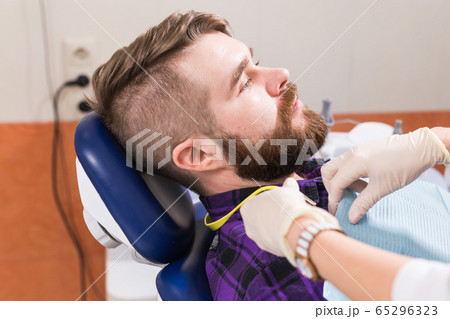 Doctor and patient in the dental clinic. dentistry and dental health concept. Doctor and patient in the dental clinic. dentistry and dental health concept. 65296323