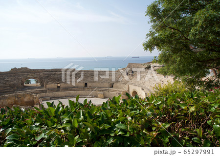 TARRAGONA, SPAIN - AUG 28th, 2017: a panoramic view of the ancient roman amphitheater next to the Mediterranean sea TARRAGONA, SPAIN - AUG 28th, 2017: a panoramic view of the ancient roman amphitheater next to the Mediterranean sea 65297991