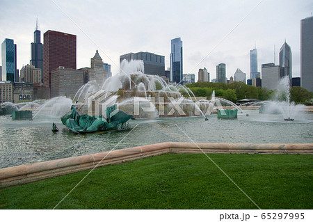 CHICAGO, ILLINOIS, UNITED STATES - MAY 11th, 2018: Buckingham Fountain is one of the largest in the world, in the windy city's Grant Park on a beautiful spring day with skyline or buildings in the CHICAGO, ILLINOIS, UNITED STATES - MAY 11th, 2018: Buckingham Fountain is one of the largest in the world, in the windy city's Grant Park on a beautiful spring day with skyline or buildings in the 65297995