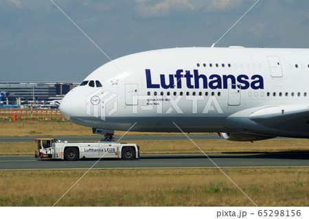 FRANKFURT, GERMANY - JUN 09th, 2017: Airbus A380 of Lufthansa with registration D-AIMH moves on taxiway by tow truck before departure from FRA airport 65298156