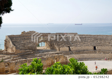 TARRAGONA, SPAIN - AUG 28th, 2017: a panoramic view of the ancient roman amphitheater next to the Mediterranean sea TARRAGONA, SPAIN - AUG 28th, 2017: a panoramic view of the ancient roman amphitheater next to the Mediterranean sea 65298242