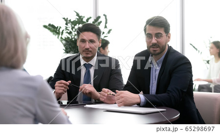 During meeting between bank managers and client considering loan getting 65298697