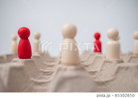 A wooden figure standing with team to influence 65302650