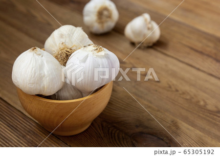 Isolated garlic whole on wooden background. Cooking ingredient. Copy space. Isolated garlic whole on wooden background. Cooking ingredient. Copy space. 65305192