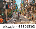 Woman is making a picture of Hanoi city railway Perspective view running along narrow street with houses in Vietnam 65306593