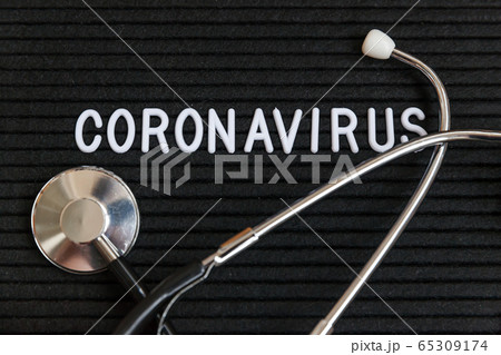 Text phrase Coronavirus and stethoscope on black 65309174