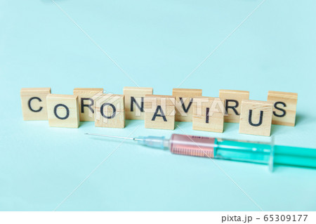 Text phrase Coronavirus and syringe on blue pastel 65309177