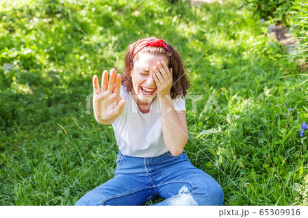 Happy girl smiling outdoor. Beautiful young 65309916