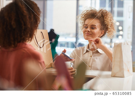 Young Woman Buying Clothes in Mall 65310085