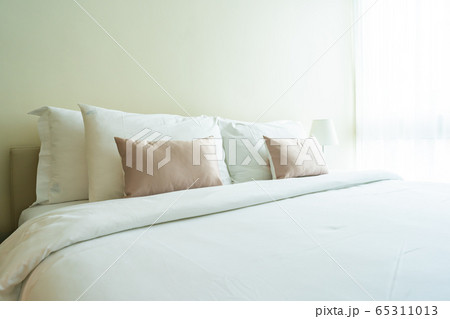 White comfortable pillow on bed decoration interior White comfortable pillow on bed decoration interior 65311013