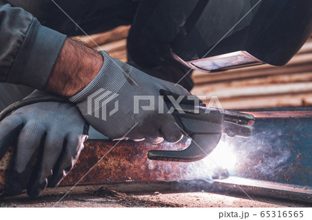 Welding work, Man Welding in Workshop. Metalwork and Sparks. Construction and Industrial concept. Welding work, Man Welding in Workshop. Metalwork and Sparks. Construction and Industrial concept. 65316565