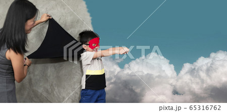 The mother played with her son in home, the son was really imagining himself flying in the sky.Family concepts And development of young children. The mother played with her son in home, the son was really imagining himself flying in the sky.Family concepts And development of young children. 65316762