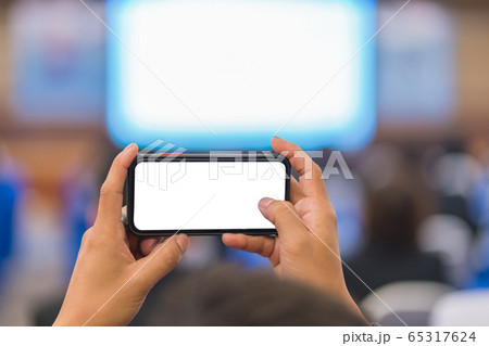 Man taking photo to speaker on the stage present in conference hall or seminar meeting,  65317624