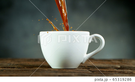 pouring coffee drink with splashing liquid. 65319286