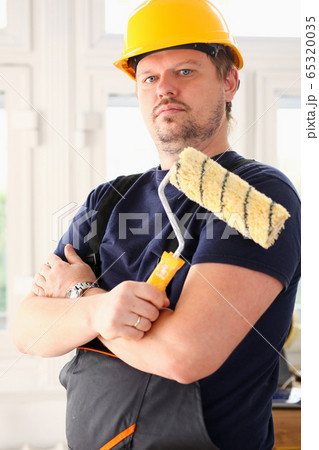 Smiling worker hold brush portrait 65320035