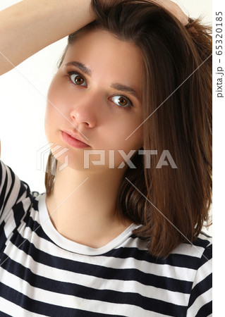 Fashion model woman face large portrait on a gray background Fashion model woman face large portrait on a gray background 65320185