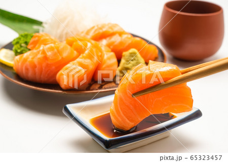 Sashimi, Salmon, Japanese food chopsticks and wasabi with withe plate isolated Sashimi, Salmon, Japanese food chopsticks and wasabi with withe plate isolated 65323457