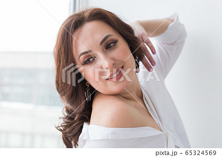 Close-up portrait of beautiful young woman with elegant luxurious jewelry and bijouterie. 65324569