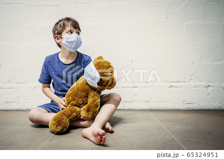 Young boy and his teddy bear wearing protective Young boy and his teddy bear wearing protective 65324951