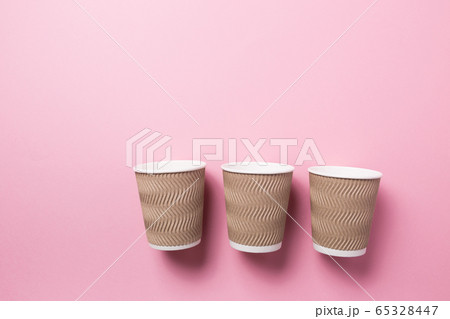 Paper cup for hot coffee or tea on a pink isolated background. Paper cup for hot coffee or tea on a pink isolated background. 65328447