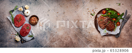 Meat banner background. Raw beef meat on slate and grilled beef steaks with salad 65328906