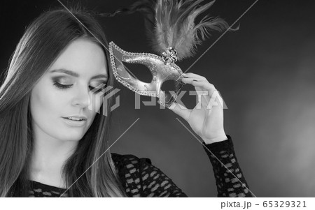 Sensual lady holding carnival mask. Sensual lady holding carnival mask. 65329321