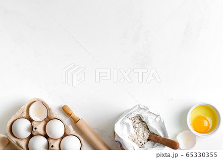 Baking ingredients for making homemade traditional bread or cakes on a light grey marble background. 65330355