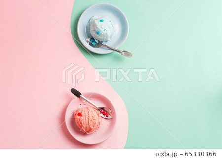 Two plates with fresh natural homemade fruits ice-cream or gelato on a duotone background as a symbol of yin and yang. Two plates with fresh natural homemade fruits ice-cream or gelato on a duotone background as a symbol of yin and yang. 65330366