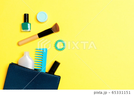 Make up products spilling out of cosmetics bag on Make up products spilling out of cosmetics bag on 65331151