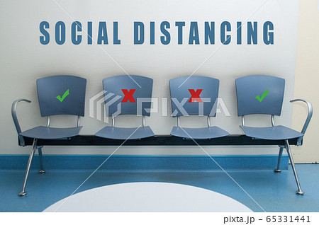 chair alignment in a waiting room with symbol on seat for the social distancing during the Covid-19 pandemic 65331441