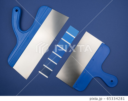 Blue spatula on a blue background. Blue still life with color palette. Blue spatula on a blue background. Blue still life with color palette. 65334281