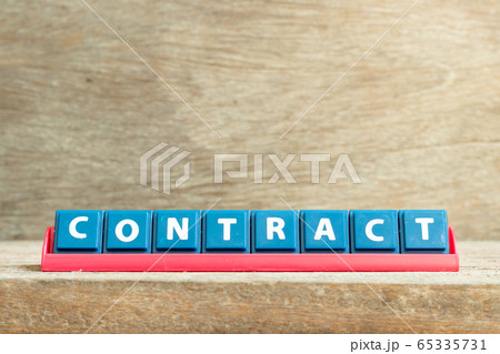 Tile letter on red rack in word contract on wood background 65335731