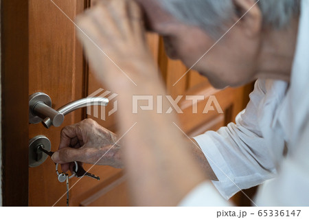 Tired elderly with hand on her forehead,trying to open the door,unlocking,having trouble seeing key,vision problems, blurred vision,opening the locked door,asian senior woman with eyesight problem Tired elderly with hand on her forehead,trying to open the door,unlocking,having trouble seeing key,vision problems, blurred vision,opening the locked door,asian senior woman with eyesight problem 65336147