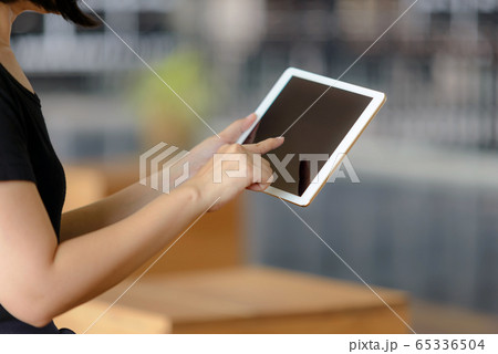 Close-up of businesswoman using a digital tablet Close-up of businesswoman using a digital tablet 65336504