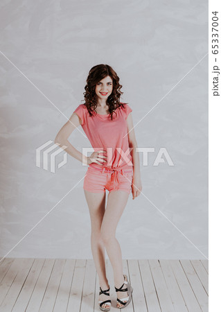Portrait of a beautiful fashionable pinup woman with pink clothes 65337004