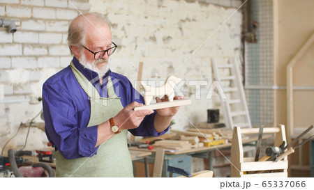 Carpenter makes a toy from natural and environmentally friendly wood Carpenter makes a toy from natural and environmentally friendly wood 65337066