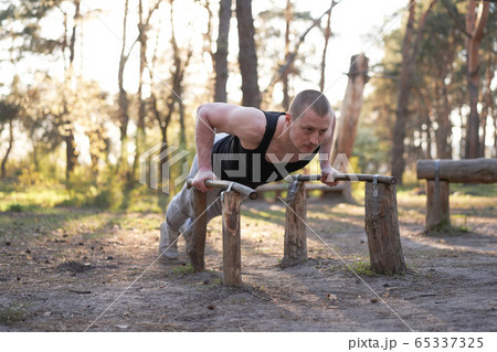 Handsome caucasian men push up outdoor workout Handsome caucasian men push up outdoor workout 65337325