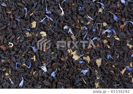 Tea with dried orange and cornflower petals background. Can be used as background. Tea with dried orange and cornflower petals background. Can be used as background. 65338292