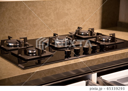 Modern clean kitchen cabinets and glass ceramic 65339293