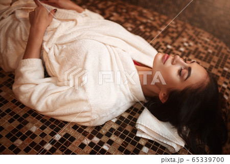 Woman lying on a hot stone, turkish hamam, sauna 65339700