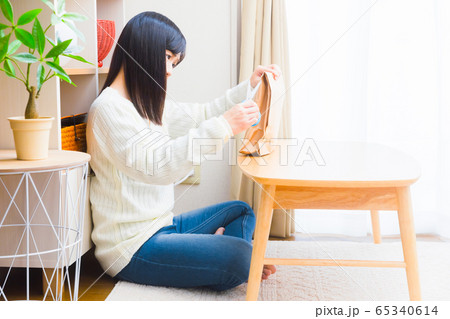 荷物を開封すべきか悩む女性　コピースペース 65340614