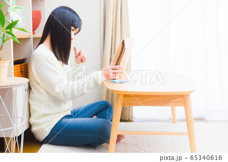 小包みを見て悩む女性 誤配、詐欺、様々なトラブル 小包みを見て悩む女性 誤配、詐欺、様々なトラブル 65340616