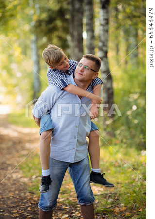 A Father and son in forest on a meadow 65343979