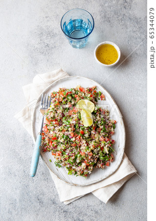 Quinoa Quinua salad with tomatoes and herbs in white bowl 65344079