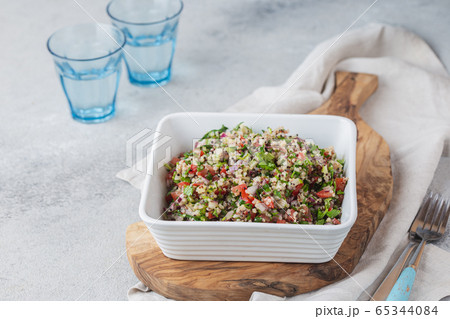 Quinoa Quinua salad with tomatoes and herbs in white bowl Quinoa Quinua salad with tomatoes and herbs in white bowl 65344084