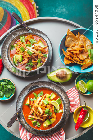 Mexican style table with spicy aztec soup with tortilla. Copy space Mexican style table with spicy aztec soup with tortilla. Copy space 65344098