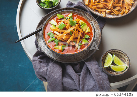 Mexican style table with spicy aztec soup with fried tortilla. Sopa azteca Mexican style table with spicy aztec soup with fried tortilla. Sopa azteca 65344108