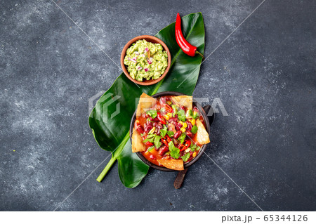 Mexican black bean soup with homemade fried tortillas totopos nachos served with guacamole 65344126