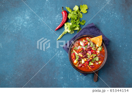 Mexican chile bean soup on blue background 65344154